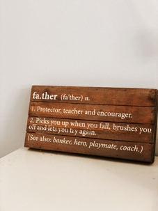 definition of father on wood board