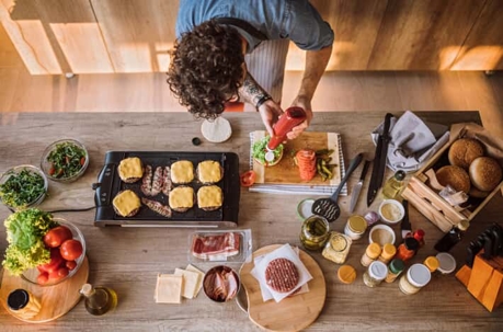 Person making hamburgers.