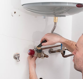 Technician fixing water heater