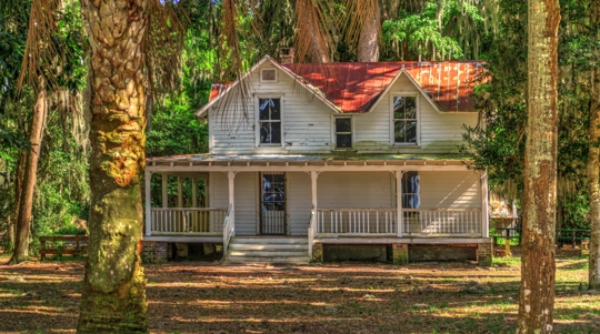 An old Florida home, raised on pillars with wraparound porch