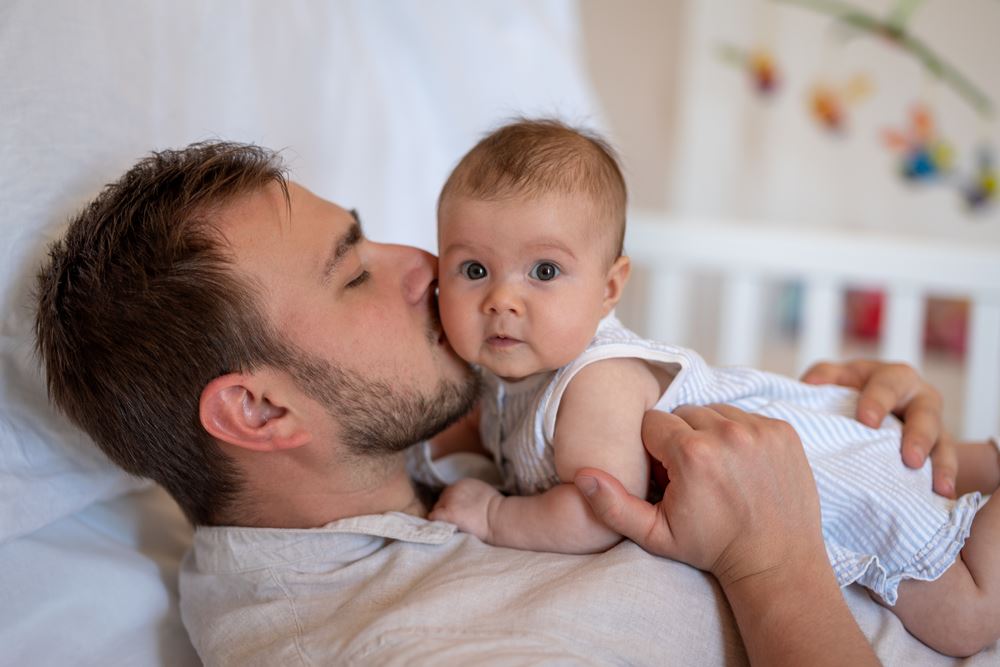 father kissing baby