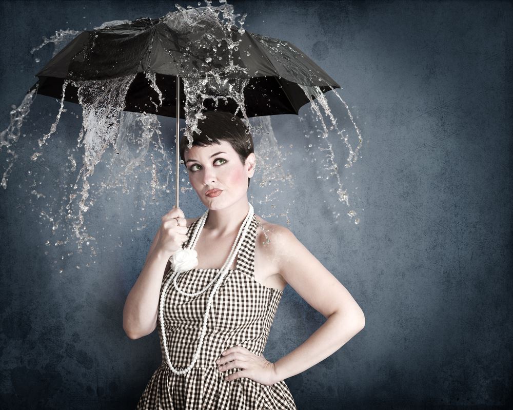 woman in sundress under umbrella and rain