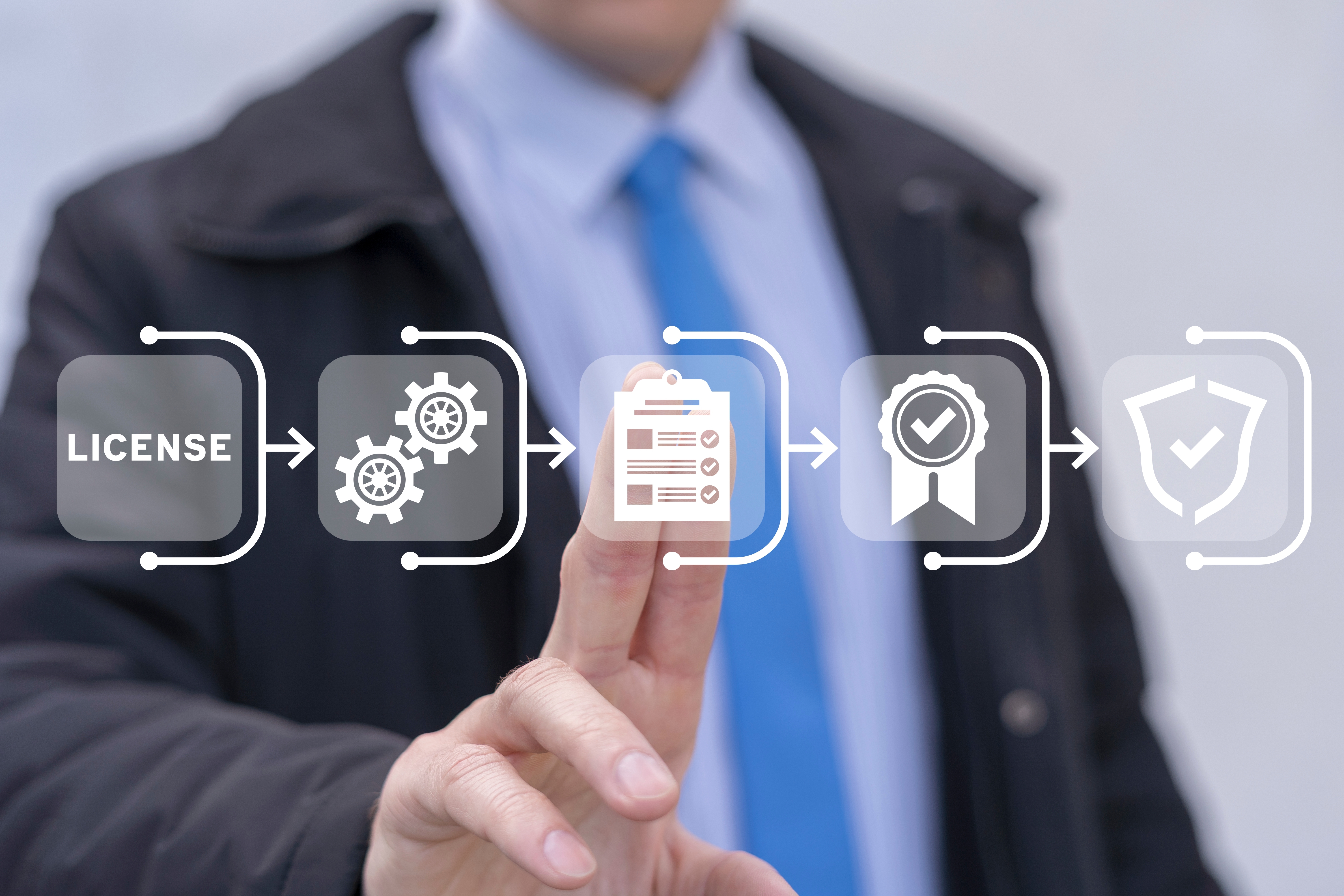 man at touch screen looking at the licensing procedure