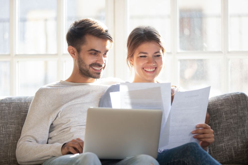 smiling couple looking at maintenance agreement