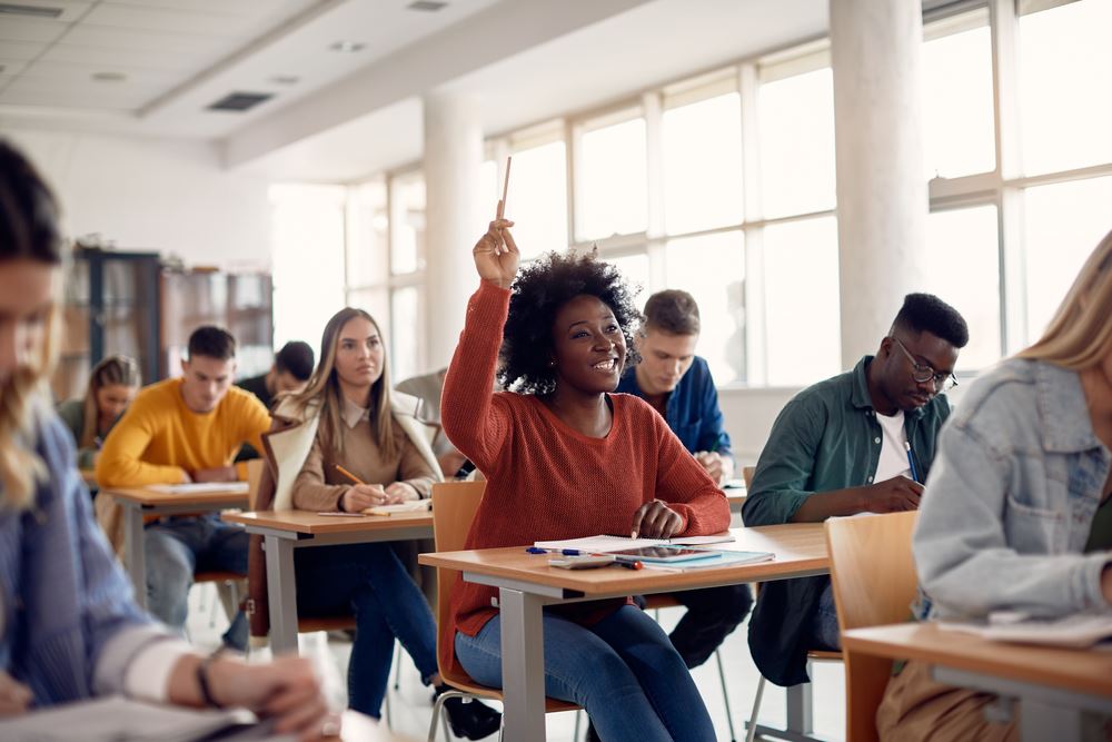 adult student raising hand in a classroom