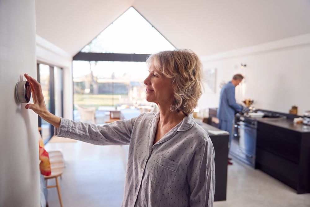 woman checking thermostat