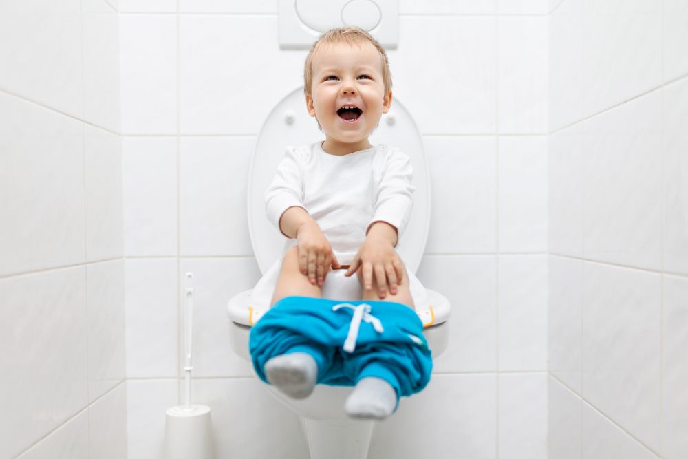 laughing toddler on toilet