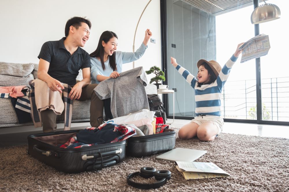 family laughing and packing for vacation