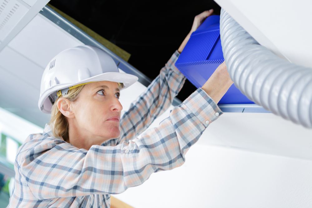 Woman HVAC tech doing an install